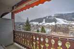 This stunning property boasts breathtaking views of snow-capped mountains and a charming town from its private balcony.