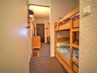 Cozy bunk beds in a charming hallway, perfect for a family getaway.