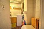 This cozy bathroom boasts a bathtub, toilet, and washing machine, perfect for a comfortable stay.