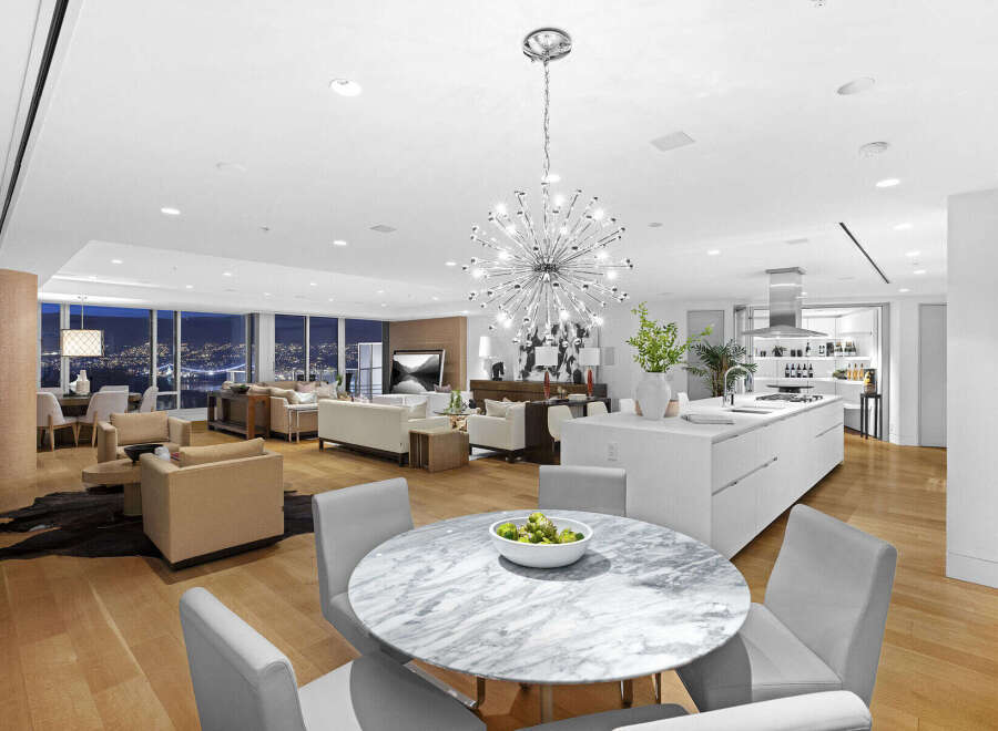 This luxurious condo boasts an open-concept layout with hardwood floors, floor-to-ceiling windows offering stunning city views, and a modern kitchen with high-end appliances.