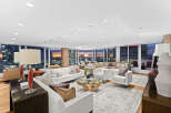 This luxurious condo boasts breathtaking panoramic city views from its expansive windows, creating a bright and airy atmosphere.