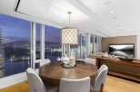This luxurious condo boasts breathtaking panoramic city views from its floor-to-ceiling windows, creating a bright and airy atmosphere.