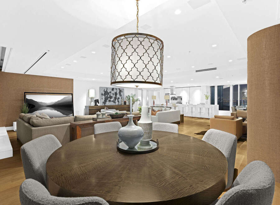 This luxurious condo boasts an open-concept living space with hardwood floors, a modern kitchen, and floor-to-ceiling windows offering stunning city views.