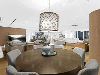 This luxurious condo boasts an open-concept living space with hardwood floors, a modern kitchen, and floor-to-ceiling windows offering stunning city views.