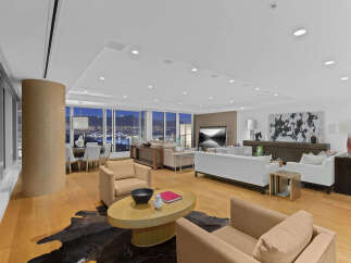 This luxurious condo boasts breathtaking panoramic city views from its expansive windows, creating a bright and airy atmosphere.
