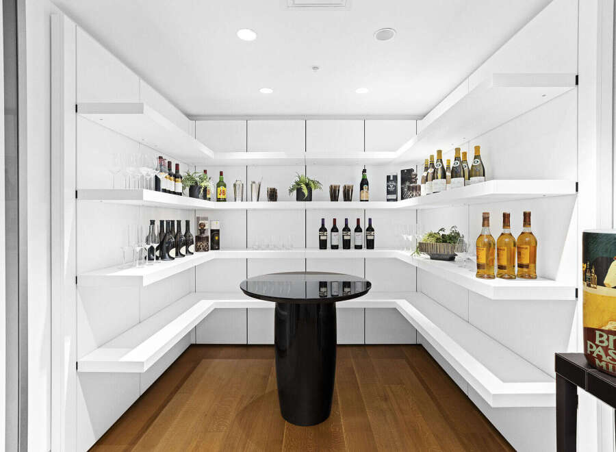 This stunning home boasts a built-in bar with ample shelving for wine and liquor, perfect for entertaining guests.
