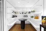 This stunning home boasts a built-in bar with ample shelving for wine and liquor, perfect for entertaining guests.