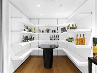 This stunning home boasts a built-in bar with ample shelving for wine and liquor, perfect for entertaining guests.