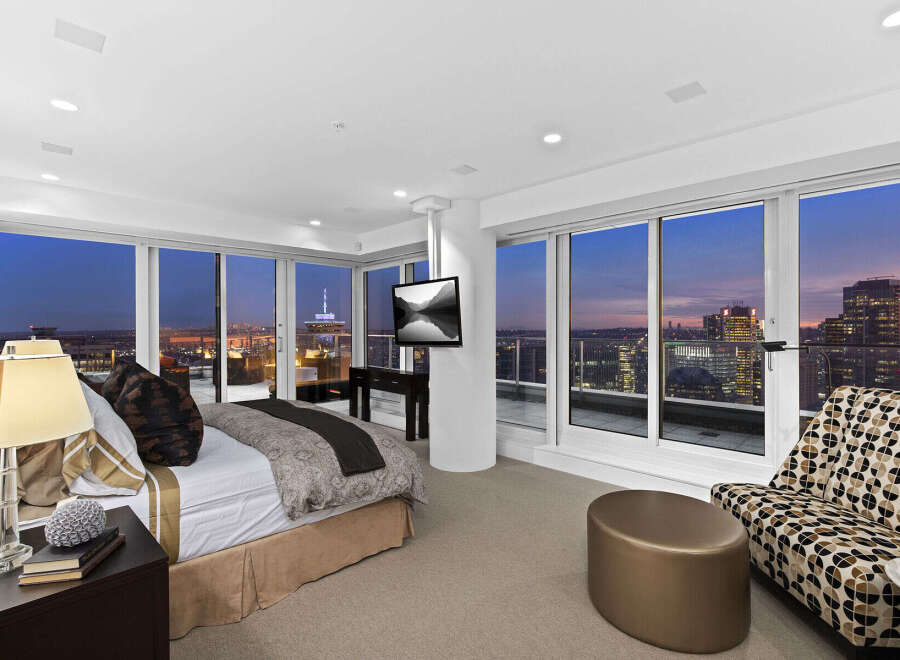 Luxury penthouse bedroom with breathtaking city views.