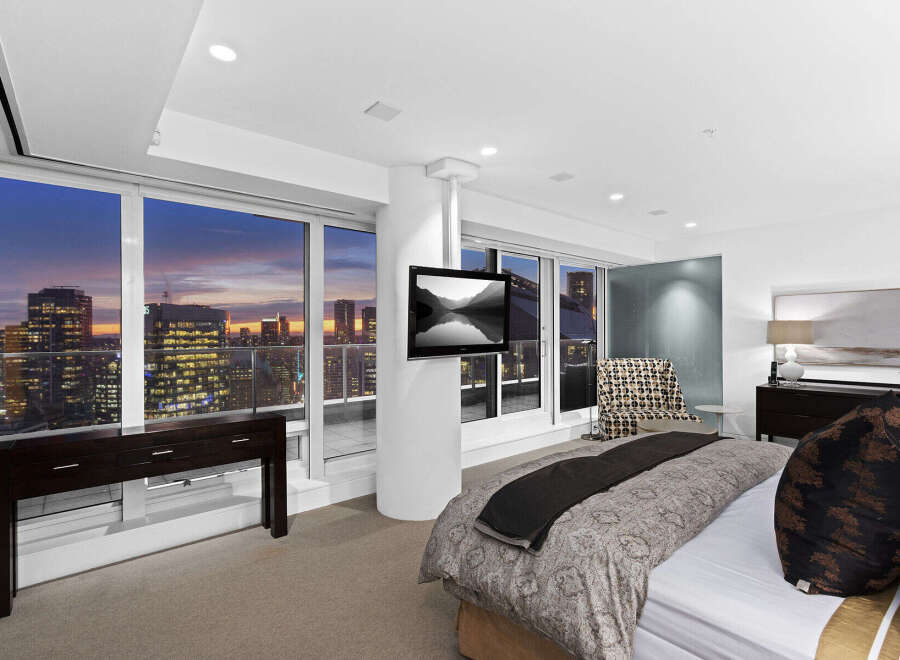 Luxury high-rise condo with breathtaking city views from floor-to-ceiling windows.