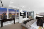 Luxury high-rise condo with breathtaking city views from floor-to-ceiling windows.
