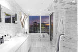 Luxury bathroom with stunning city views.