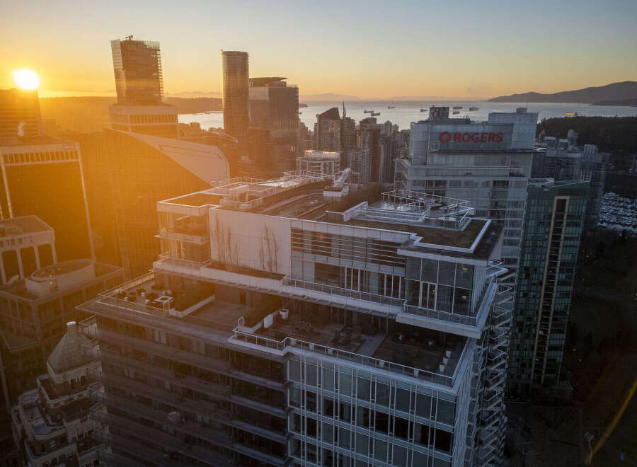 Luxury penthouse with expansive rooftop terrace offering breathtaking sunset views over the city skyline and ocean.