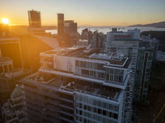 Luxury penthouse with expansive rooftop terrace offering breathtaking sunset views over the city skyline and ocean.
