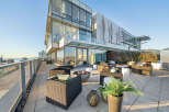 This luxurious penthouse boasts a spacious outdoor patio perfect for entertaining, complete with a fire pit, comfortable seating, and stunning city views.