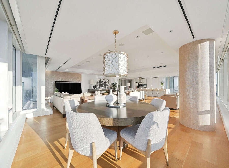 This luxurious condo boasts an open-concept living space with floor-to-ceiling windows offering breathtaking city views.