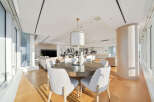 This luxurious condo boasts an open-concept living space with floor-to-ceiling windows offering breathtaking city views.