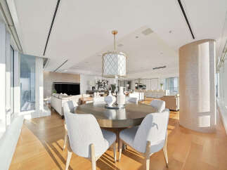 This luxurious condo boasts an open-concept living space with floor-to-ceiling windows offering breathtaking city views.
