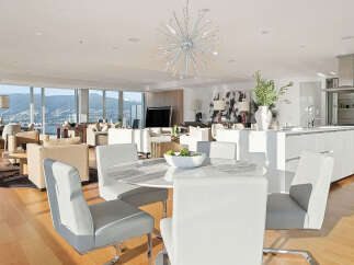 This luxurious condo boasts breathtaking panoramic views, an open-concept layout seamlessly blending the living, dining, and kitchen areas, and high-end finishes throughout.