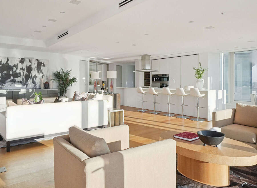 This luxurious condo boasts an open-concept living space with floor-to-ceiling windows offering breathtaking city views.