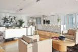 This luxurious condo boasts an open-concept living space with floor-to-ceiling windows offering breathtaking city views.