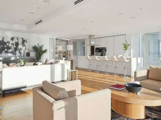 This luxurious condo boasts an open-concept living space with floor-to-ceiling windows offering breathtaking city views.