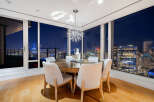 Experience luxury living with breathtaking city views from this stunning dining room.