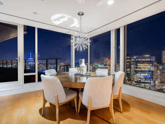 Experience luxury living with breathtaking city views from this stunning dining room.