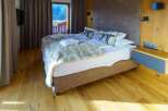 This inviting bedroom features a plush king-size bed adorned with stylish pillows and a cozy throw, creating a relaxing retreat.