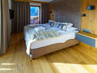 This inviting bedroom features a plush king-size bed adorned with stylish pillows and a cozy throw, creating a relaxing retreat.
