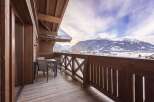This property features a charming wooden balcony with stunning mountain views, perfect for enjoying the serene alpine setting.