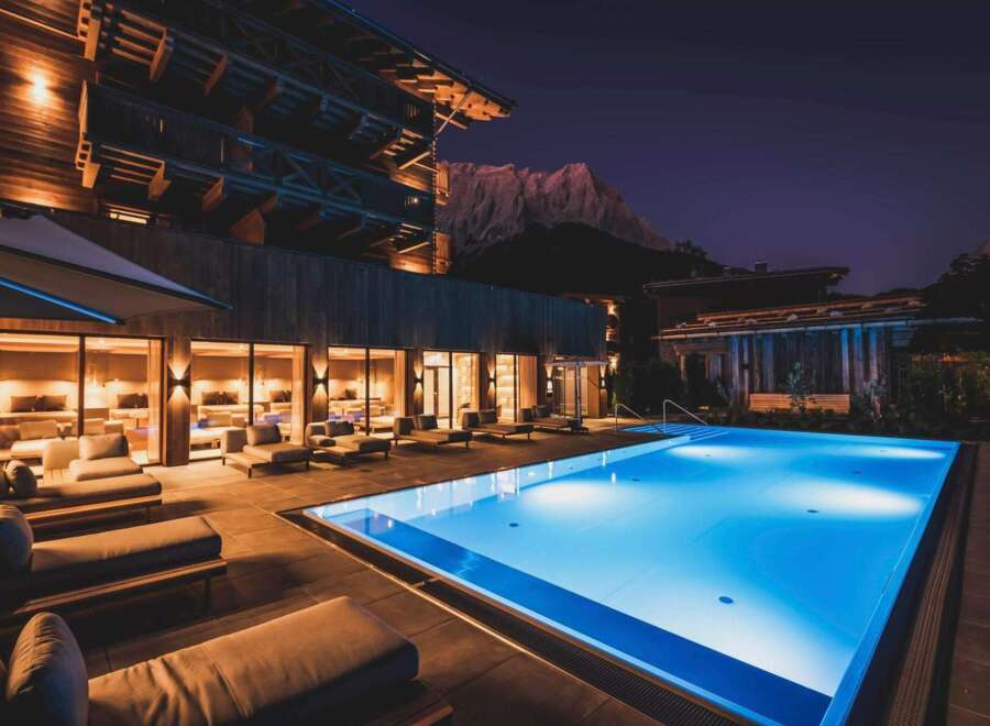 Experience luxury living with this stunning property featuring a modern pool and exquisite wooden architecture.