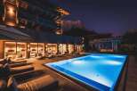 Experience luxury living with this stunning property featuring a modern pool and exquisite wooden architecture.