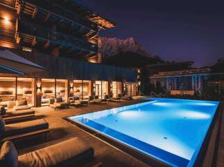 Experience luxury living with this stunning property featuring a modern pool and exquisite wooden architecture.