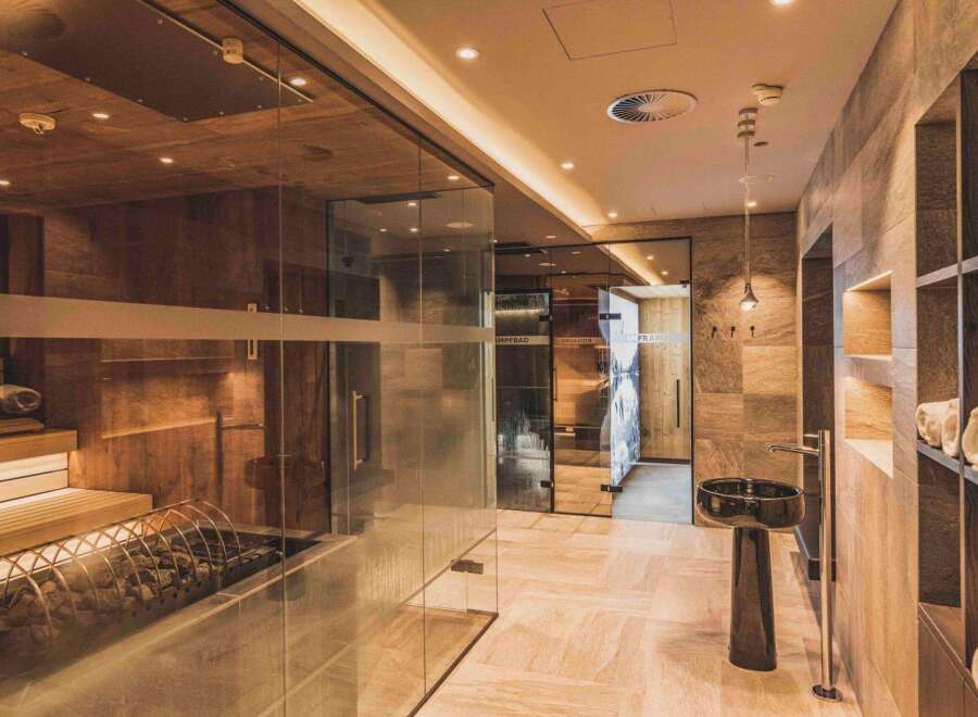 This luxurious spa area features a sauna, steam room, and infrared cabin, creating a relaxing retreat.