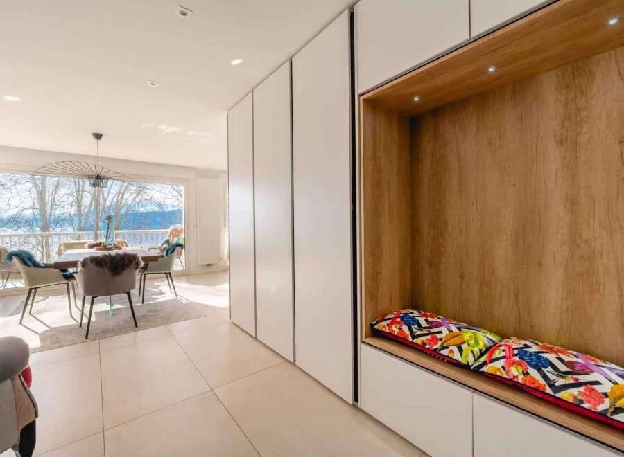 Stunning apartment boasting floor-to-ceiling windows offering breathtaking lake views.