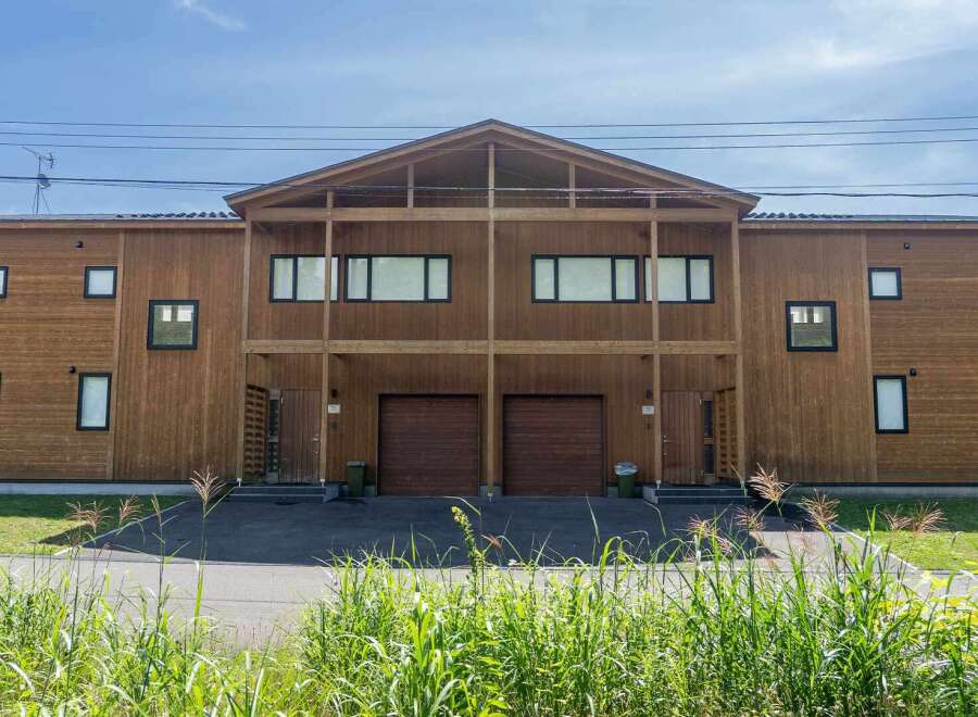 This stunning duplex boasts a modern design with a charming wooden exterior.