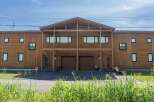 This stunning duplex boasts a modern design with a charming wooden exterior.