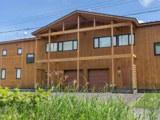 This stunning modern home boasts a sleek, contemporary design with a wood exterior, creating a warm and inviting atmosphere.