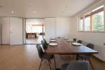 This modern dining area features a sleek, dark wood table surrounded by stylish gray chairs, perfect for enjoying meals with a view.