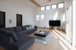 This stunning property boasts a spacious open-plan living area filled with natural light from large windows and skylights.