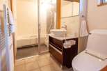This cozy bathroom boasts a modern toilet and sink, a relaxing bathtub perfect for soaking, and a shower for a quick rinse.
