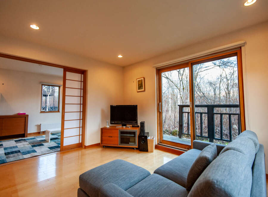 This stunning property boasts a spacious living area with large windows offering breathtaking views of the surrounding nature.