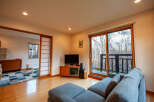 This stunning property boasts a spacious living area with large windows offering breathtaking views of the surrounding nature.