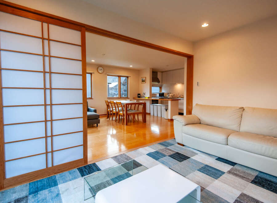This stunning property boasts an open-plan living area with a modern kitchen and dining space, perfect for entertaining.
