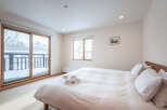 Wake up to breathtaking views of a snow-covered landscape from this cozy bedroom.