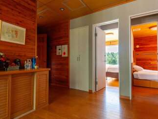 This stunning property boasts a spacious hallway with built-in wooden cabinets, offering ample storage.