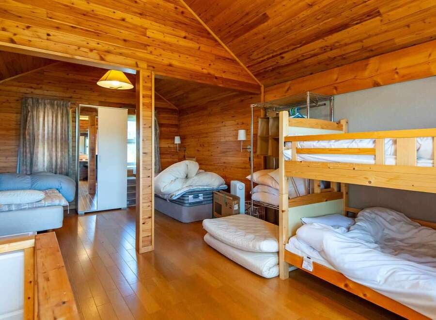 Cozy wooden cabin with a bunk bed, perfect for families or groups.