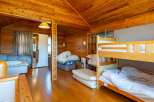 Cozy wooden cabin with a bunk bed, perfect for families or groups.
