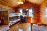 Cozy wooden cabin room with a bunk bed, perfect for a family getaway.